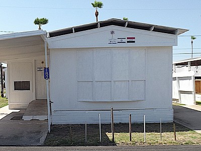 Front door is at the top of the ramp and porch